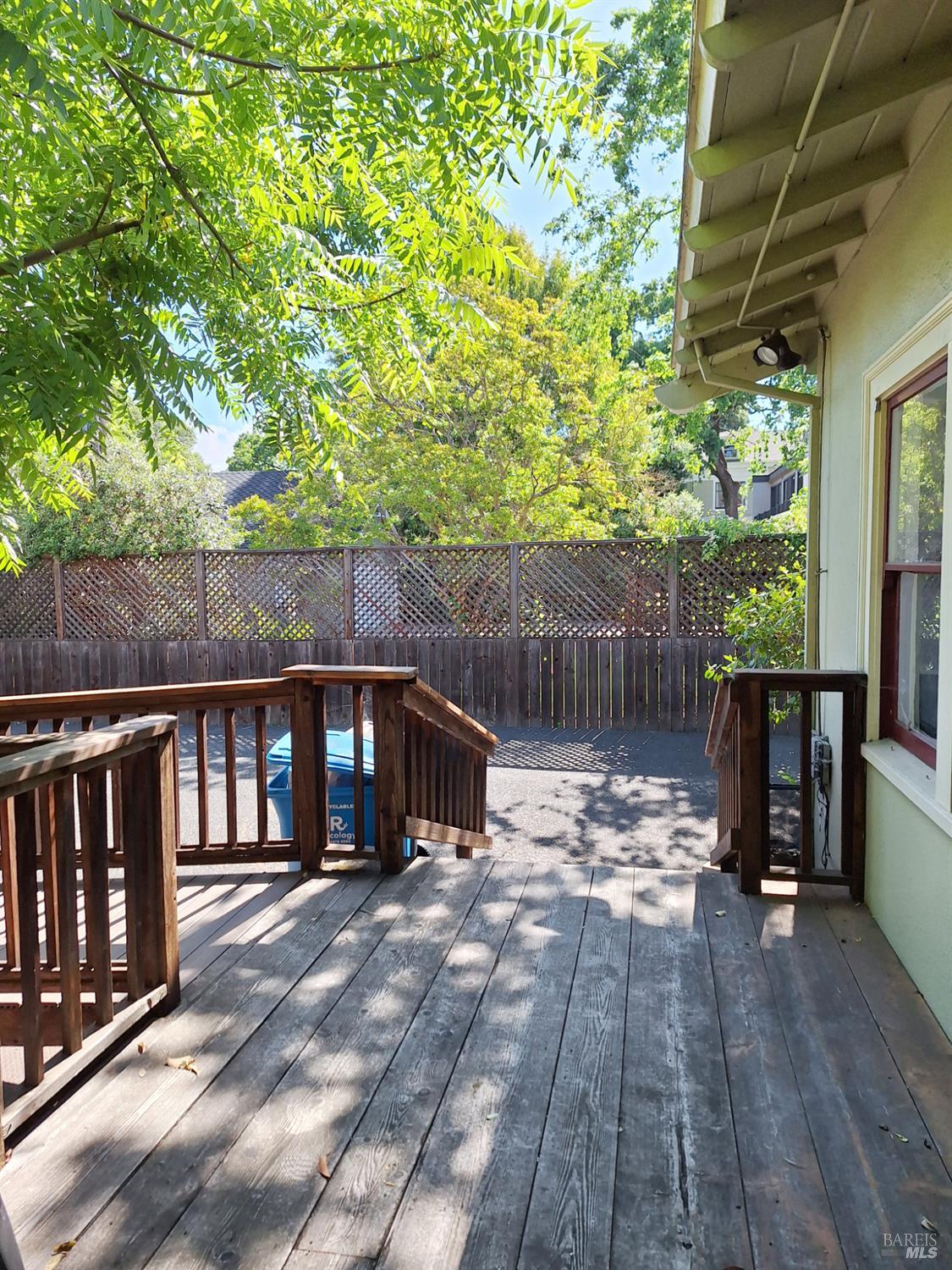 705 College Avenue Santa Rosa, CA 95404 - Photo 14 of 18 a view of a wooden deck with chairs and a yard
