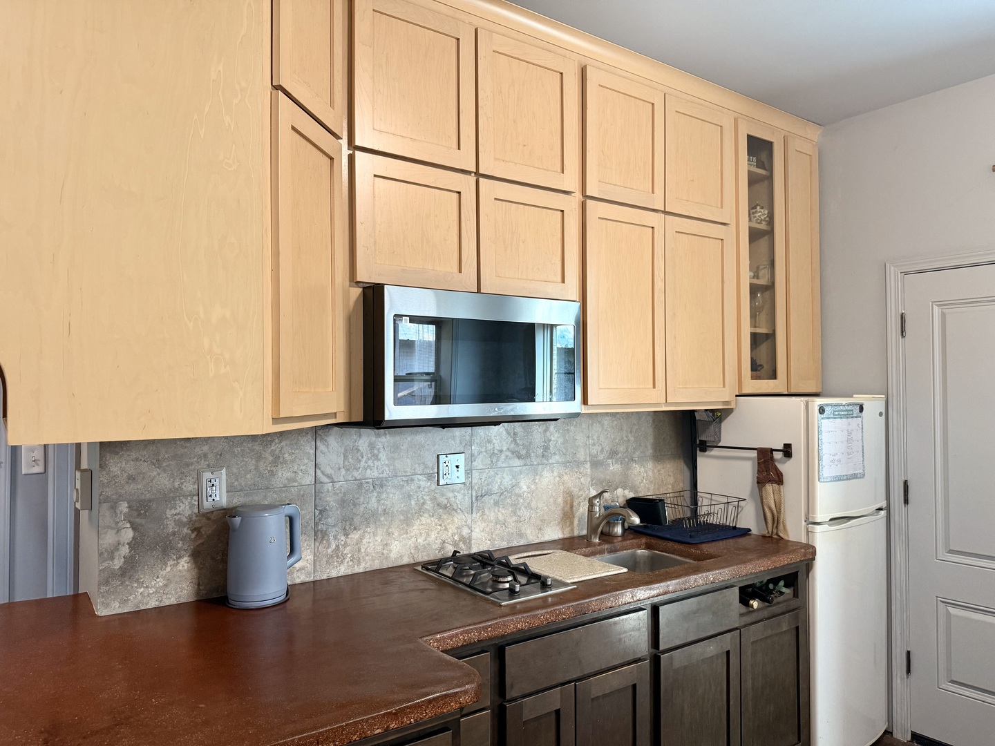 186 Peru Street Paw Paw, IL 61353 - Photo 11 of 27 a kitchen with stainless steel appliances granite countertop a sink stove and cabinets