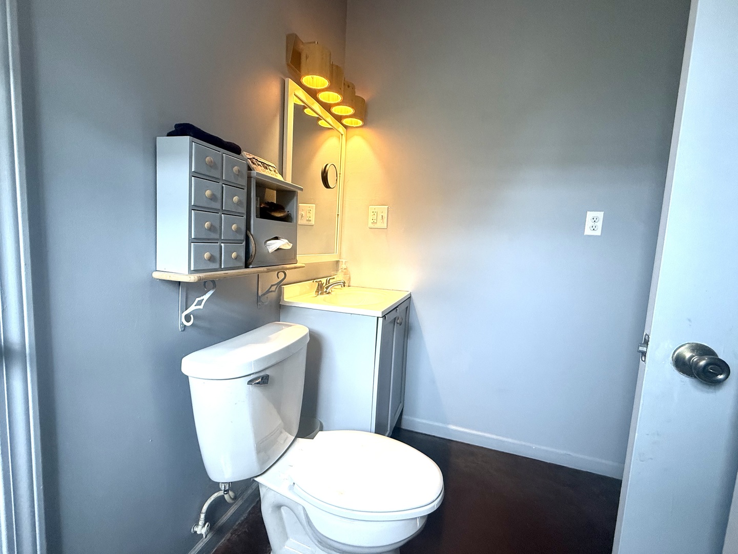 186 Peru Street Paw Paw, IL 61353 - Photo 21 of 27 a white toilet sitting next to a bathroom sink and vanity
