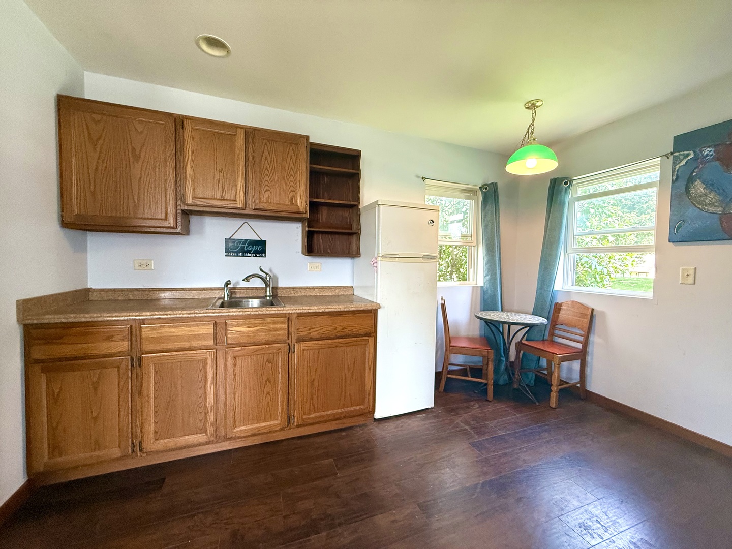 186 Peru Street Paw Paw, IL 61353 - Photo 24 of 27 a kitchen with stainless steel appliances granite countertop a stove a sink dishwasher and white cabinets with wooden floor