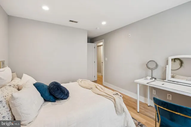 a bedroom with furniture and a flat screen tv