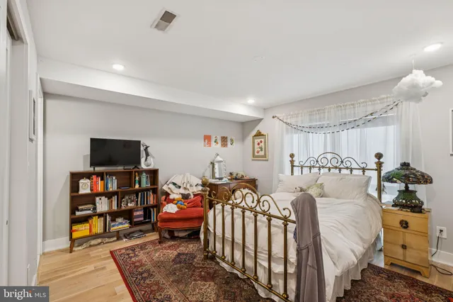 a kitchen with stainless steel appliances granite countertop a dining table chairs refrigerator and sink