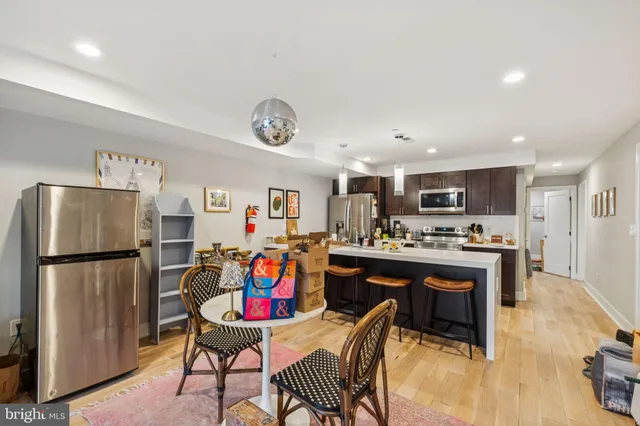 a living room with furniture a table and a flat screen tv