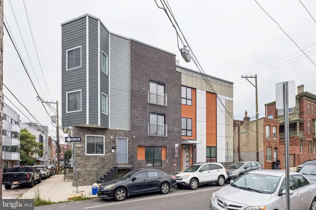 a couple of cars parked in front of a building
