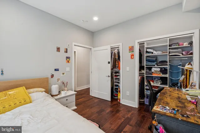 a bedroom with two beds and a chandelier