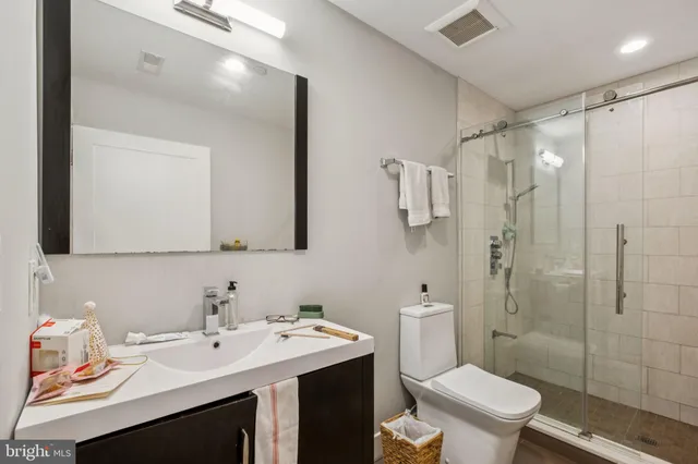 a open dining room with stainless steel appliances dining table chairs and wooden floor