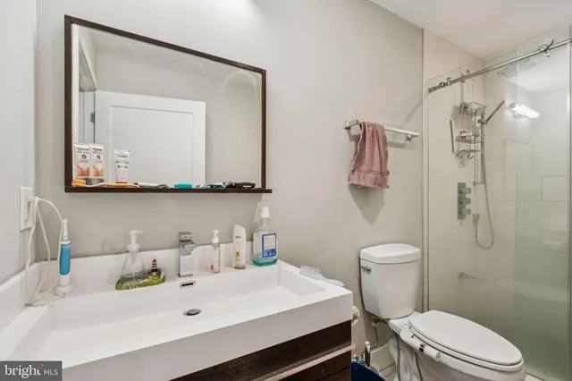 a kitchen with a stove a sink dishwasher and a refrigerator with wooden cabinets