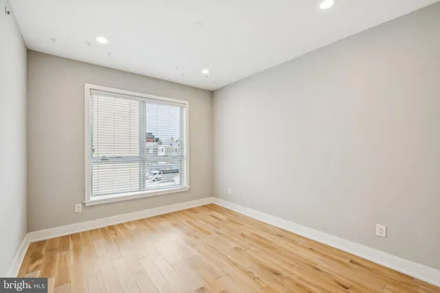 an empty room with closet and wooden floor