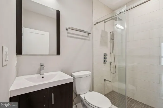 a bathroom with a toilet a sink and mirror