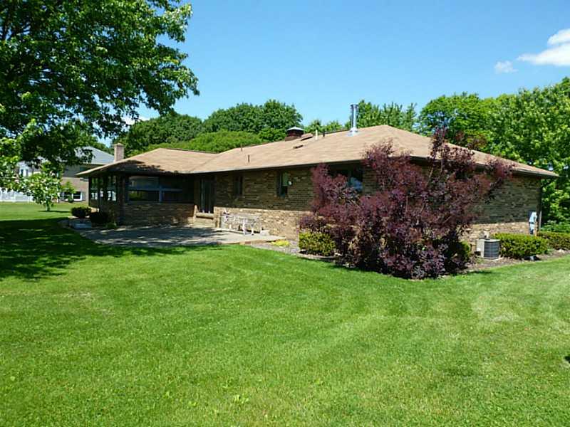 394 Maple Road Burgettstown, PA 15021 - Photo 23 of 25 Exterior Back. A rear side view of this ranch shows a concrete patio w/ both sun and shade.
