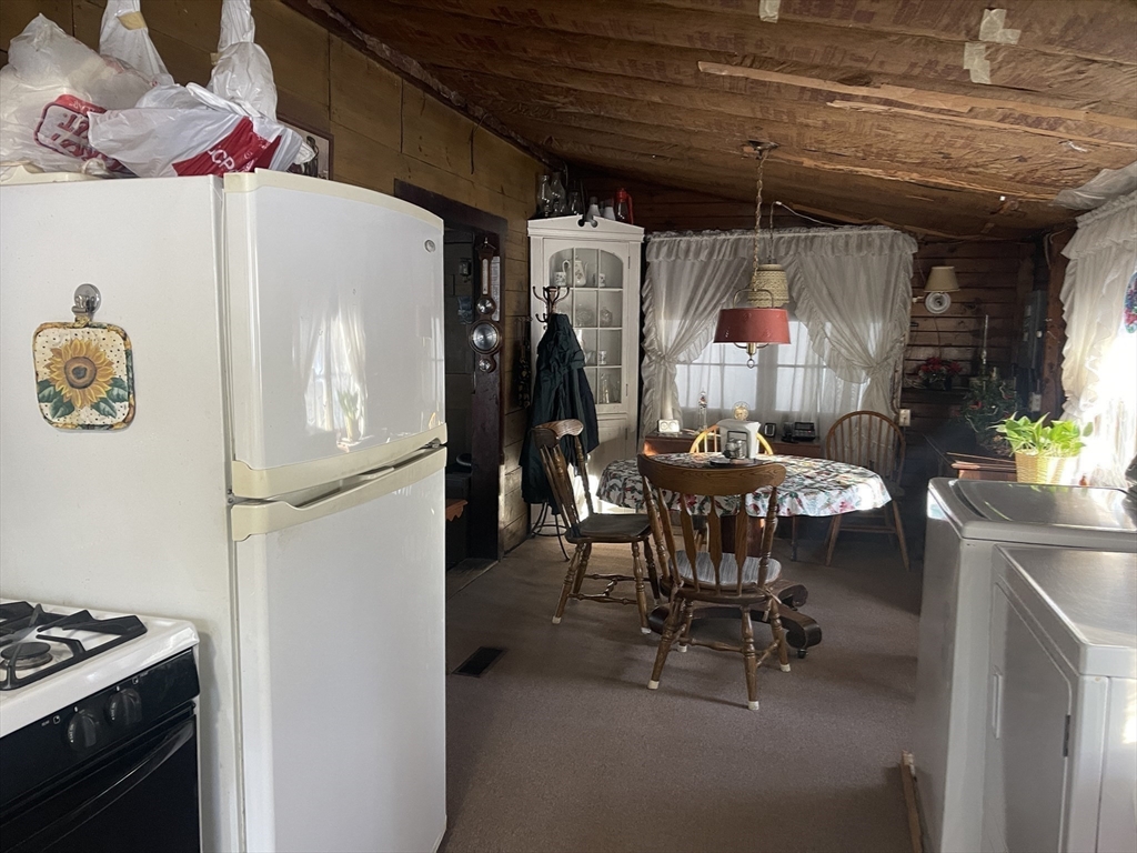 172 Shelters Road Groton, MA 01450 - Photo 14 of 40 a dining room with furniture and a chandelier