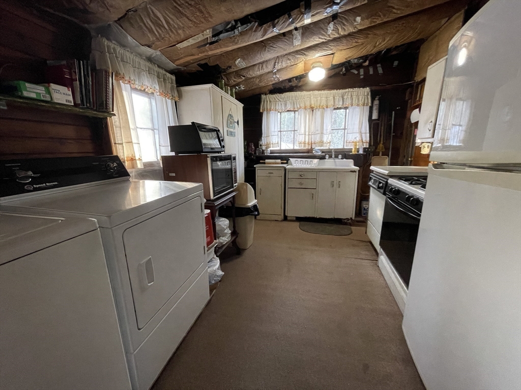 172 Shelters Road Groton, MA 01450 - Photo 15 of 40 a kitchen with a sink a counter top space stainless steel appliances and a window