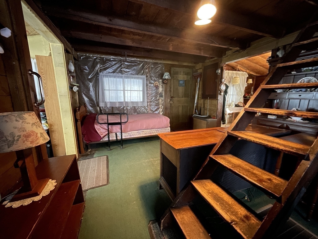 172 Shelters Road Groton, MA 01450 - Photo 22 of 40 a blue chair sitting in front of a building