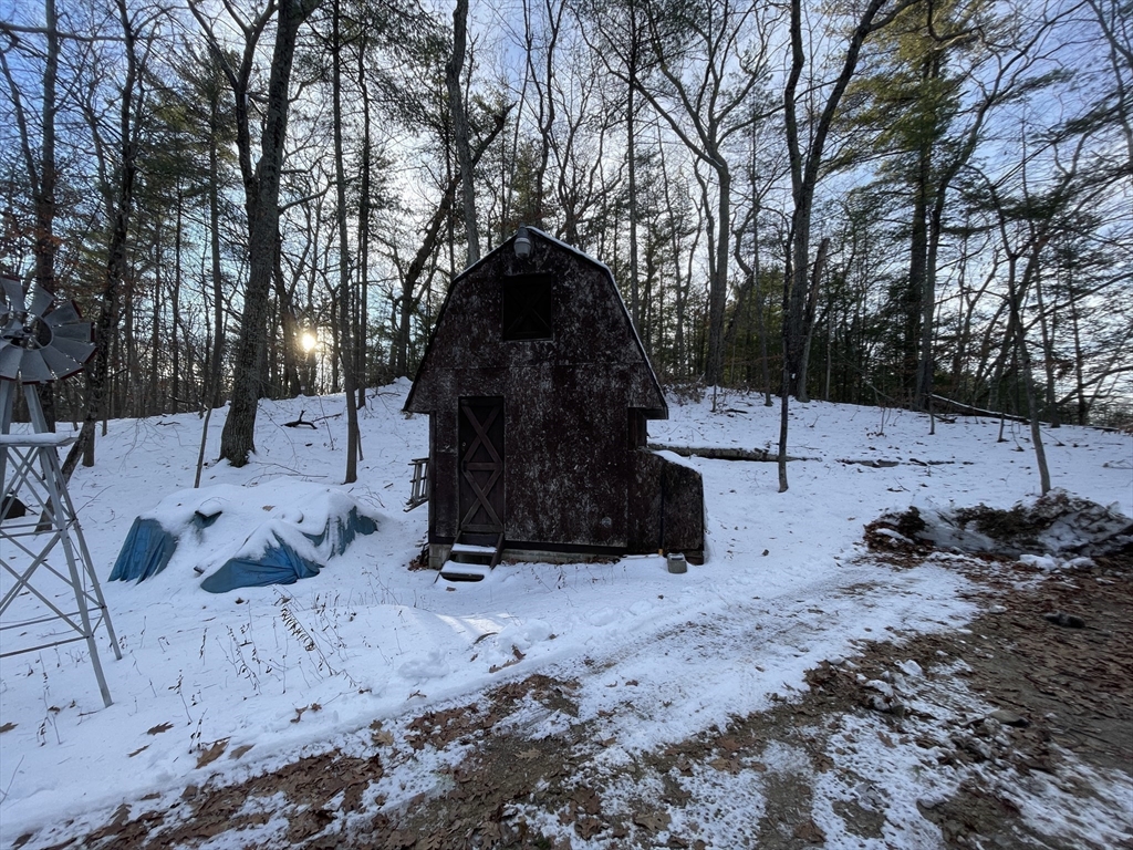 172 Shelters Road Groton, MA 01450 - Photo 7 of 40 a view of fire pit with large trees
