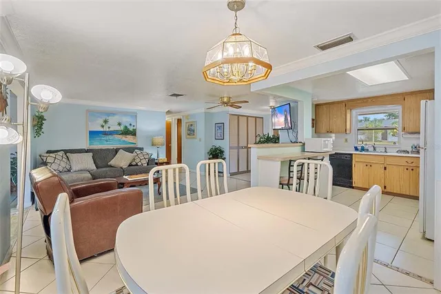 a kitchen with a stove a refrigerator and a table