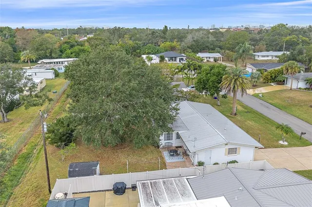 a view of a house with backyard and sitting area