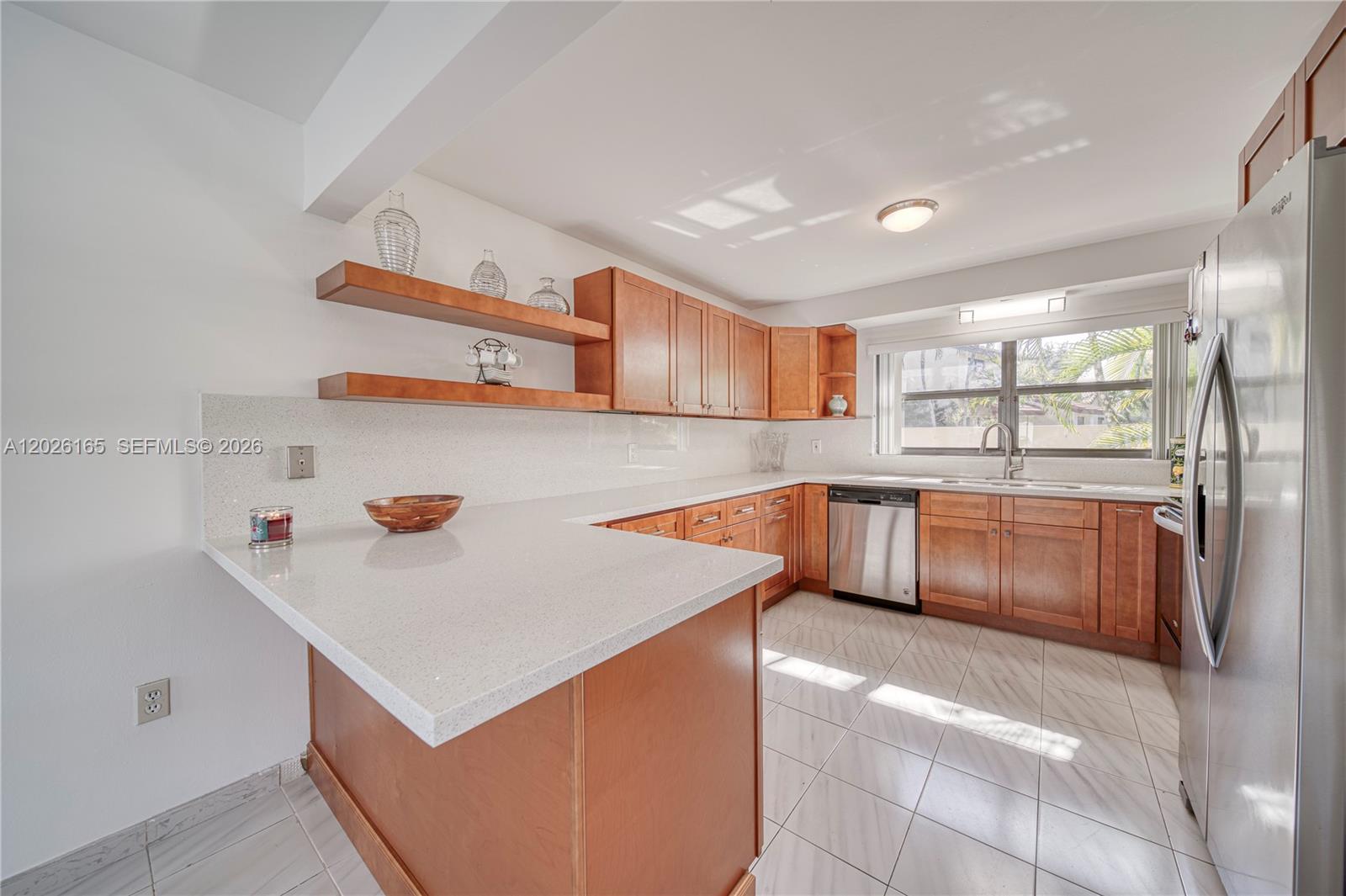 13337 Southwest 64th Lane Miami, FL 33183 - Photo 11 of 36 a kitchen with a refrigerator and a sink