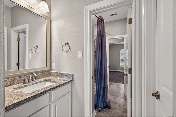 a view of a room with wooden floor and ceiling fan