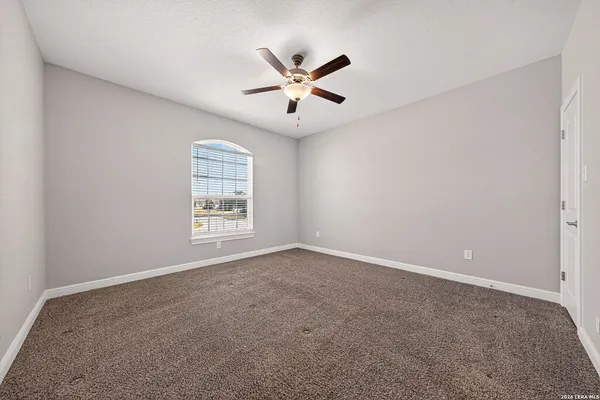 a view of a room with wooden floor and windows