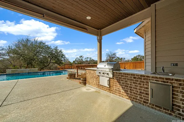 an aerial view of a house with swimming pool and mountain view