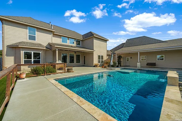 an aerial view of a house with swimming pool and glass windows
