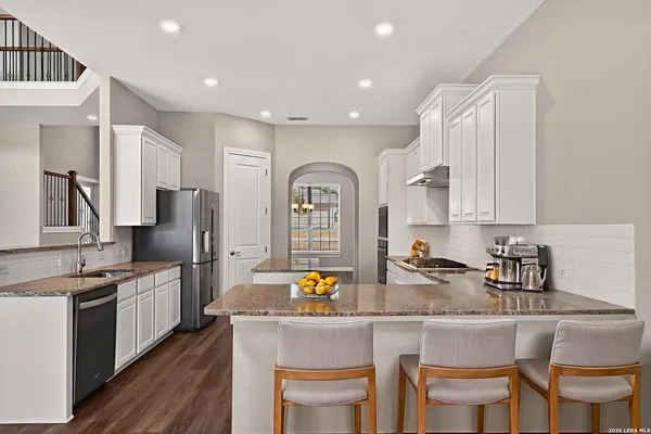 a spacious bedroom with a large bed and a flat screen television