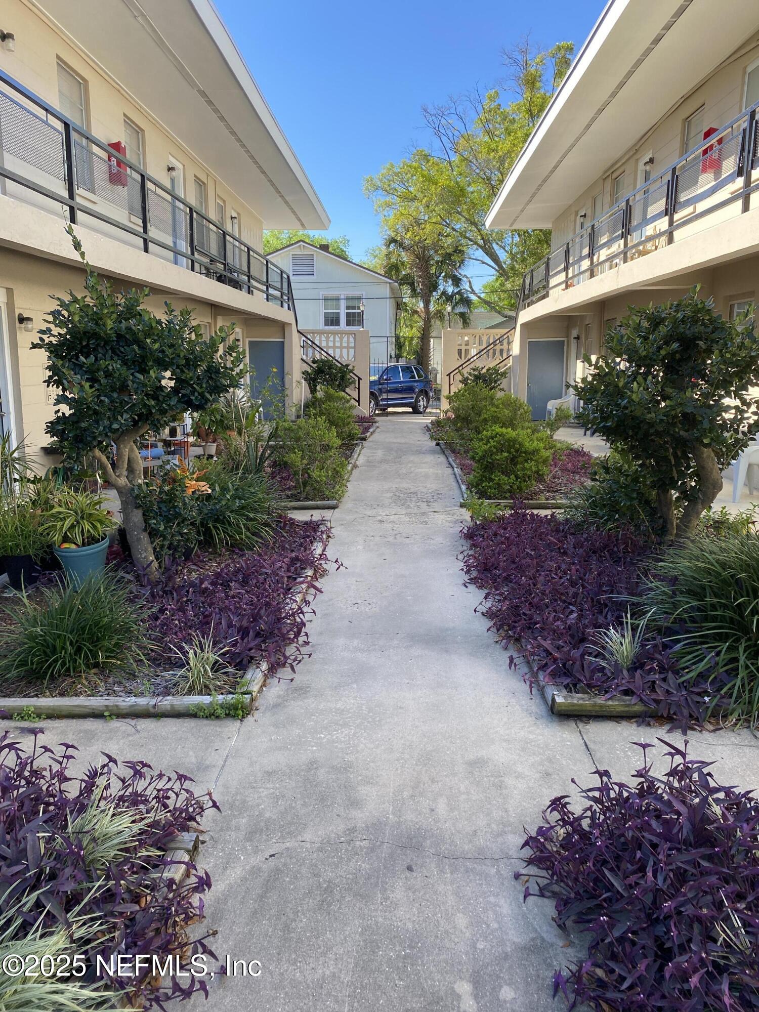 916 Childrens Way, Unit 7 Jacksonville, FL 32207 - Photo 2 of 10 a view of a building with a garden