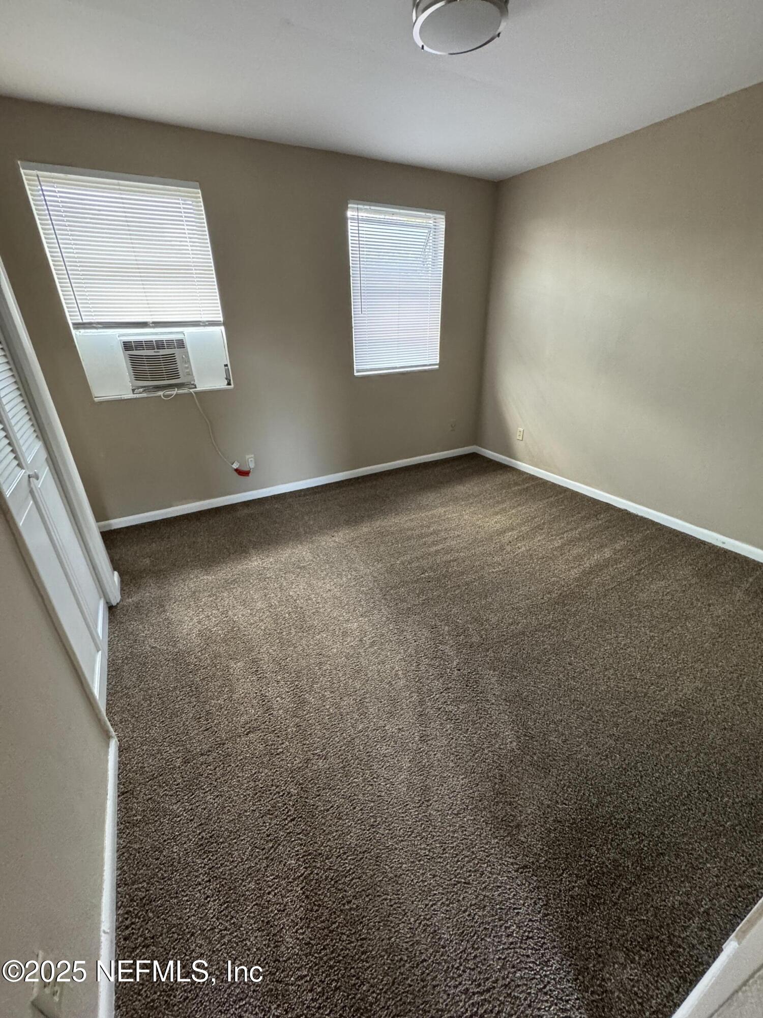 916 Childrens Way, Unit 7 Jacksonville, FL 32207 - Photo 4 of 10 an empty room with windows