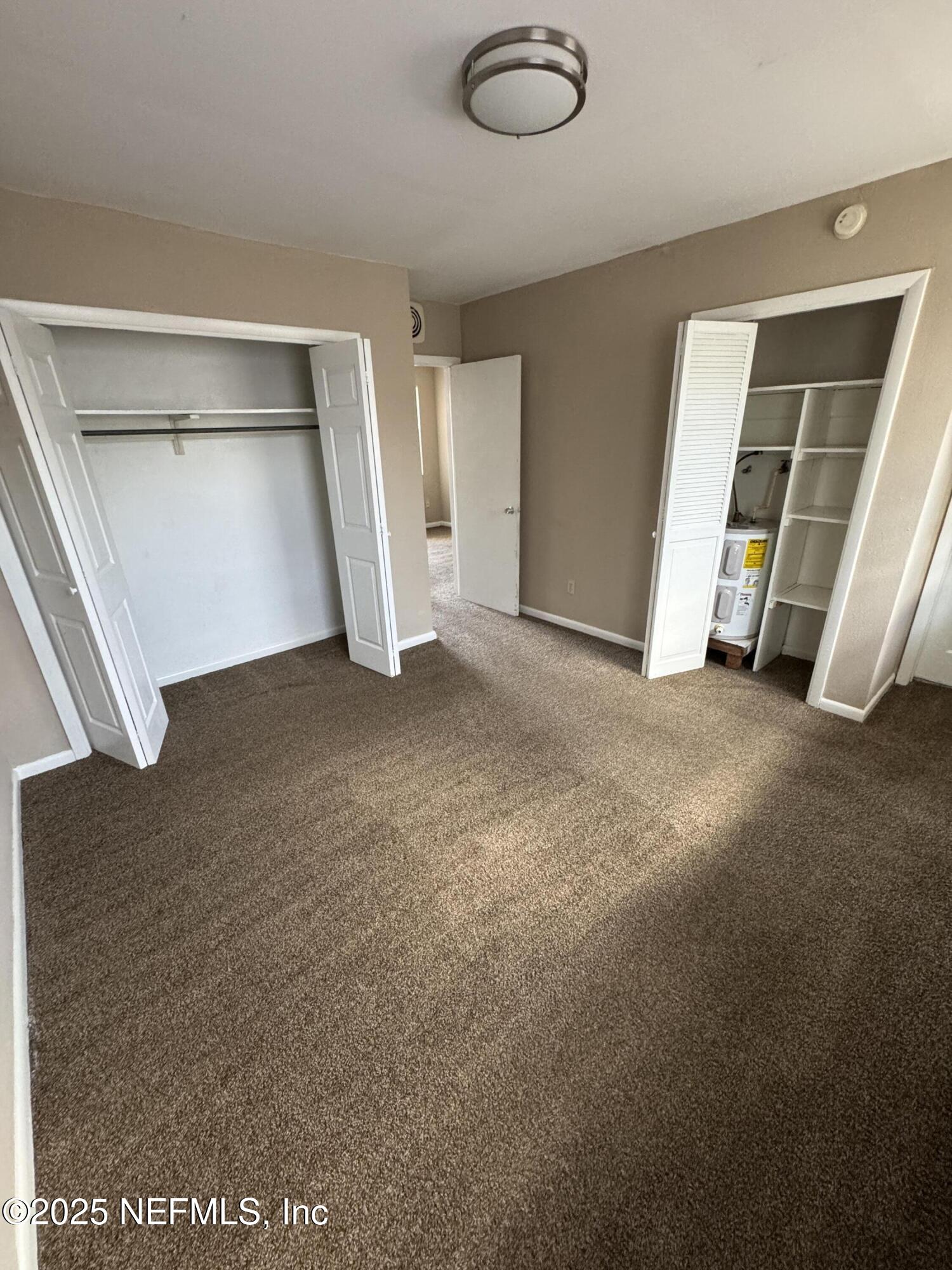 916 Childrens Way, Unit 7 Jacksonville, FL 32207 - Photo 7 of 10 an empty room with a window