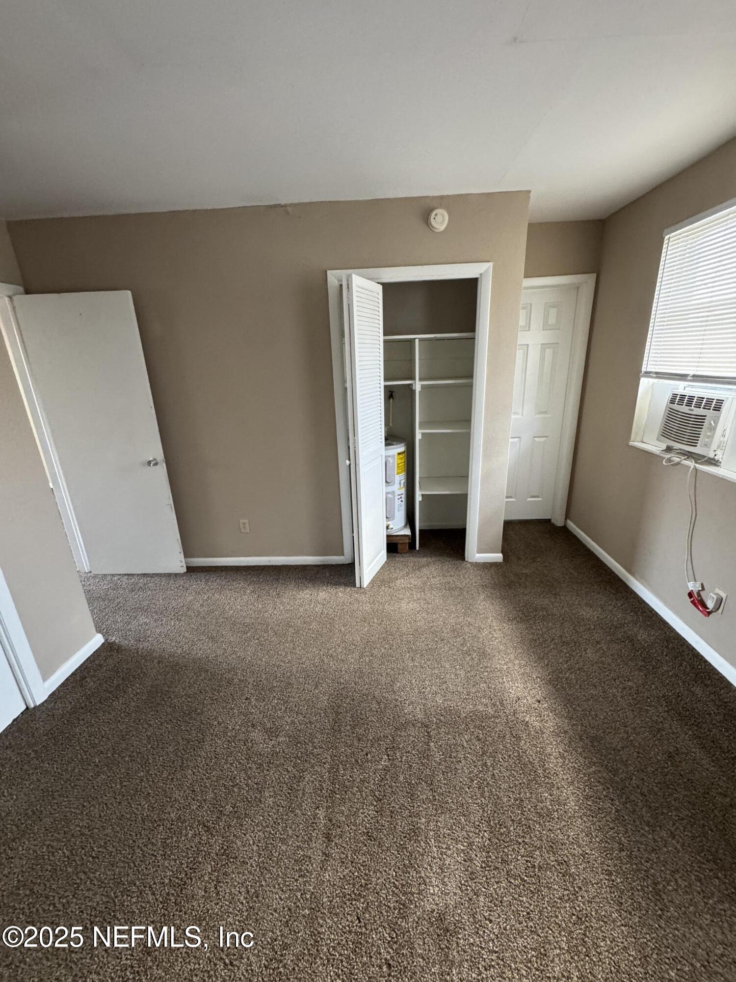 916 Childrens Way, Unit 7 Jacksonville, FL 32207 - Photo 8 of 10 an empty room with windows