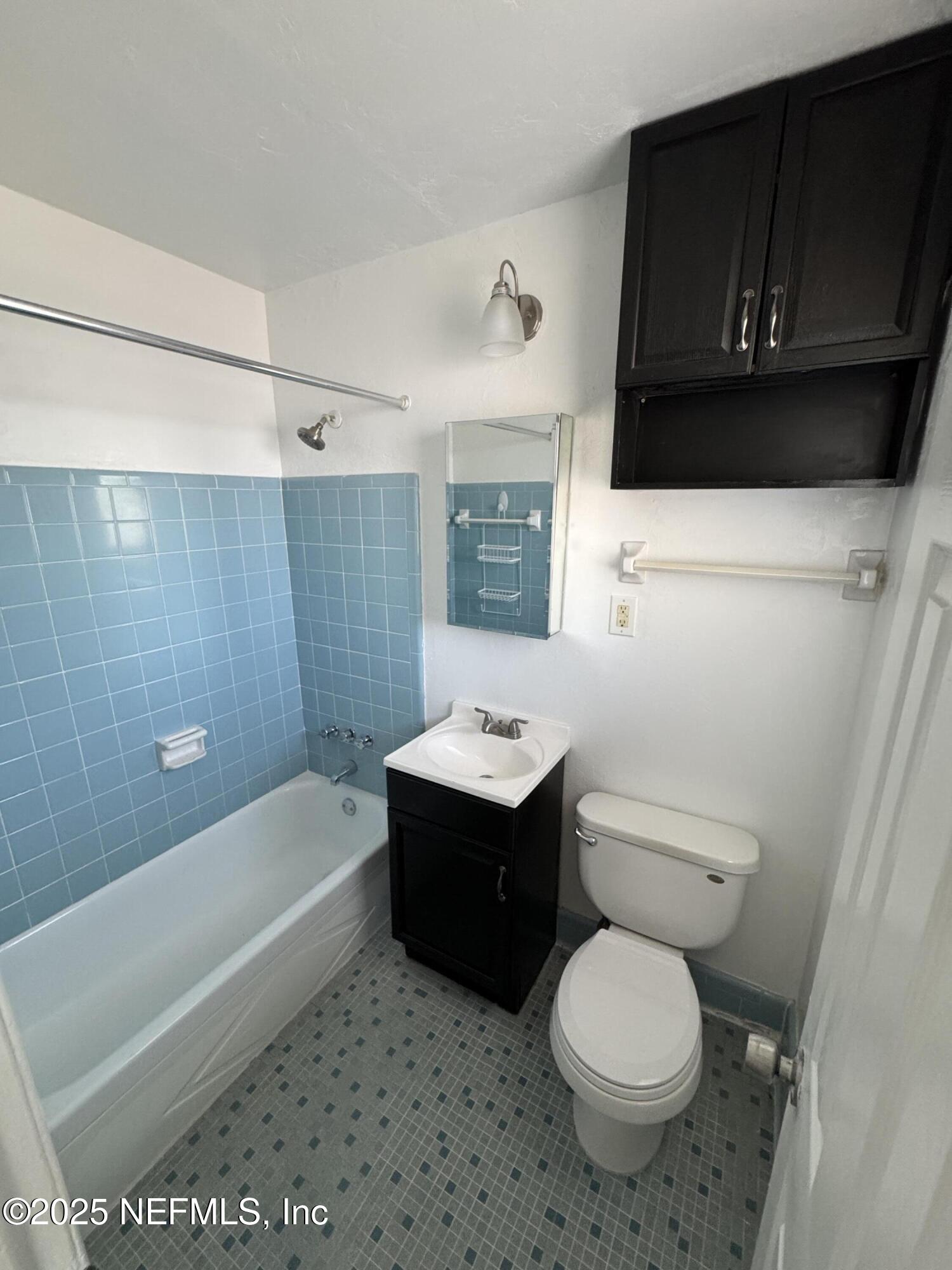 916 Childrens Way, Unit 7 Jacksonville, FL 32207 - Photo 9 of 10 a bathroom with a sink a toilet and bathtub