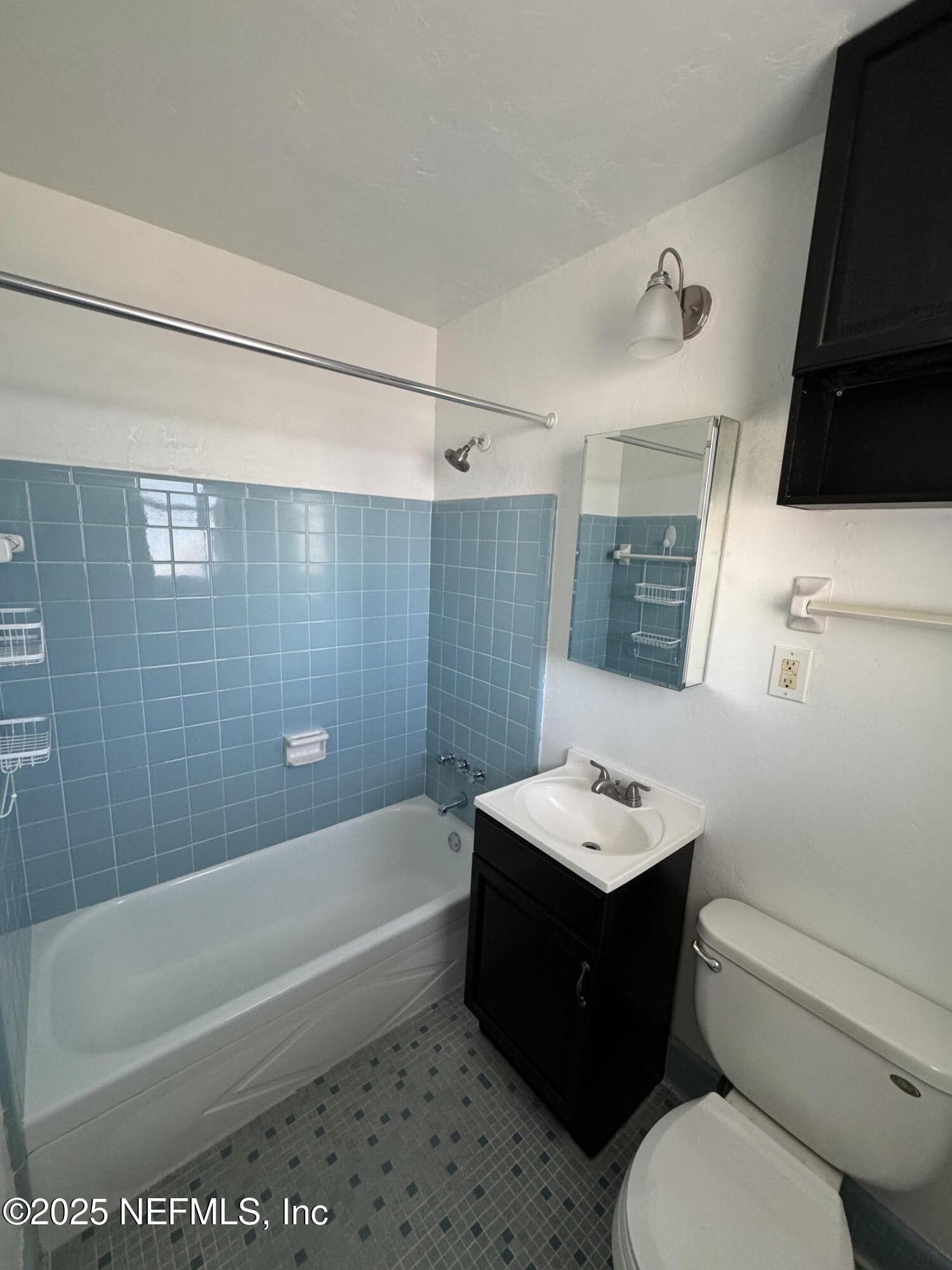 916 Childrens Way, Unit 7 Jacksonville, FL 32207 - Photo 10 of 10 a bathroom with a sink a toilet and shower