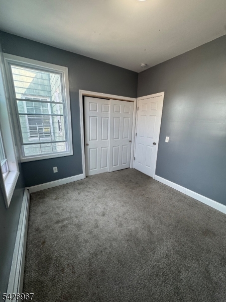 23 Elliott Street Newark, NJ 07104 - Photo 14 of 25 an empty room with a empty space and windows