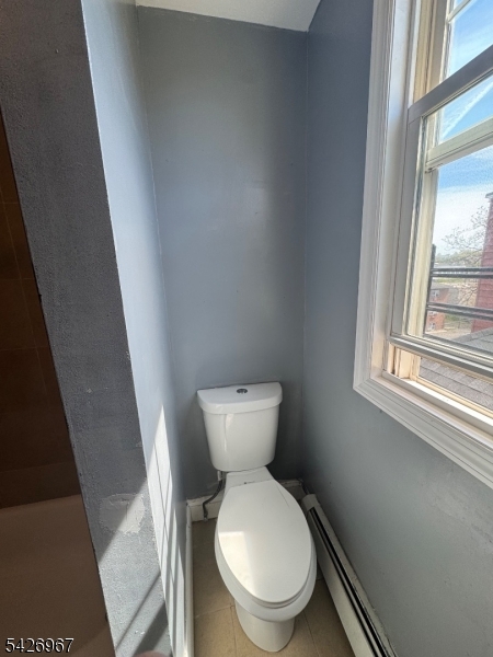 23 Elliott Street Newark, NJ 07104 - Photo 16 of 25 a white toilet sitting next to a window