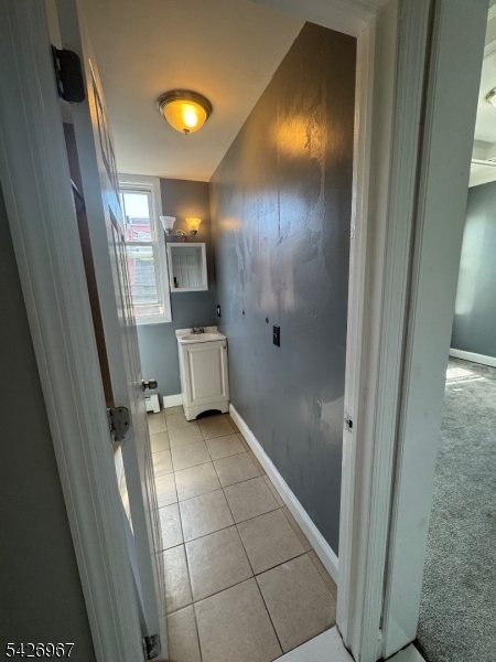 23 Elliott Street Newark, NJ 07104 - Photo 17 of 25 a bathroom with a sink and mirror