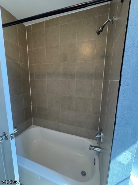 23 Elliott Street Newark, NJ 07104 - Photo 18 of 25 a bathroom with a shower and a bath tub