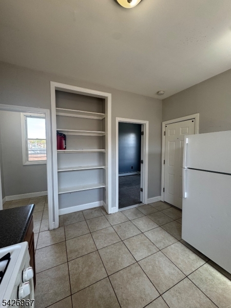 23 Elliott Street Newark, NJ 07104 - Photo 23 of 25 a view of kitchen with refrigerator and cabinets