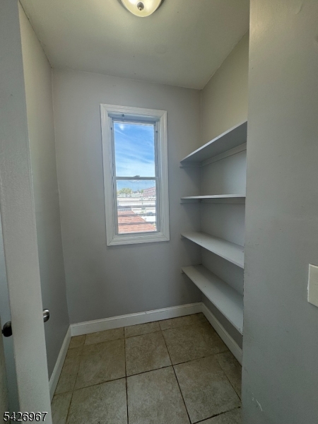 23 Elliott Street Newark, NJ 07104 - Photo 24 of 25 a storage room with washer and dryer