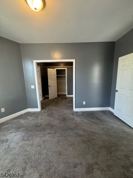 23 Elliott Street Newark, NJ 07104 - Photo 3 of 25 a view of an empty room with a fireplace