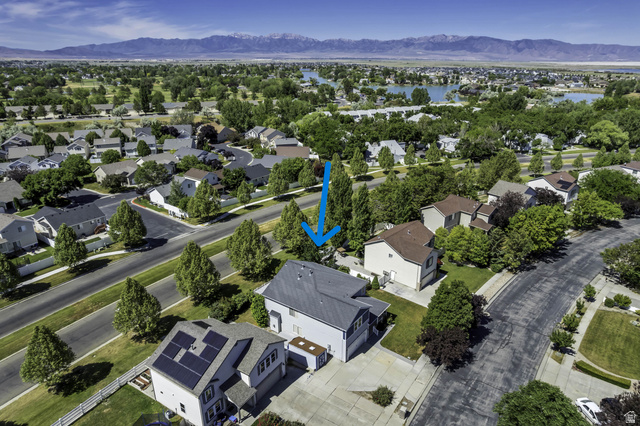 546 Wheatridge Road Tooele, UT 84074 - Photo 46 of 49 Suburban residential setting with mature trees and paved streets (blue arrow)