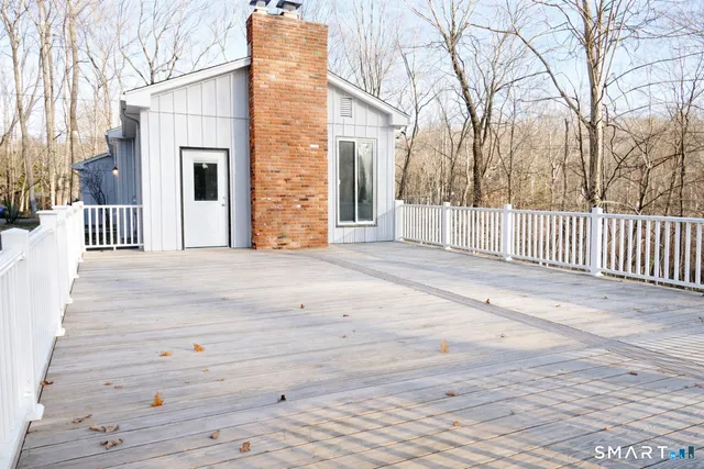 a view of a house with a wooden fence