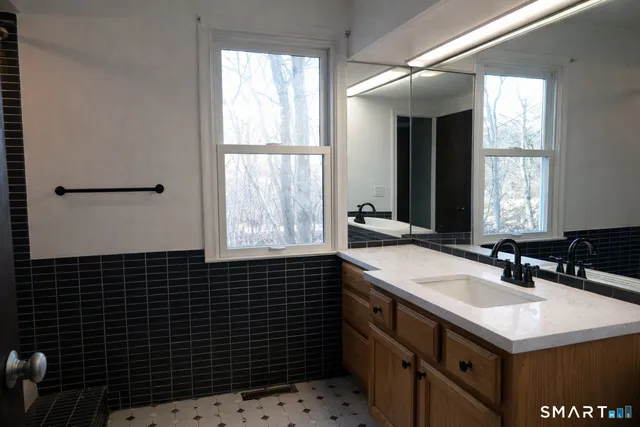 a bathroom with a sink a vanity and a mirror