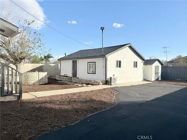 a view of a house with snow on the road