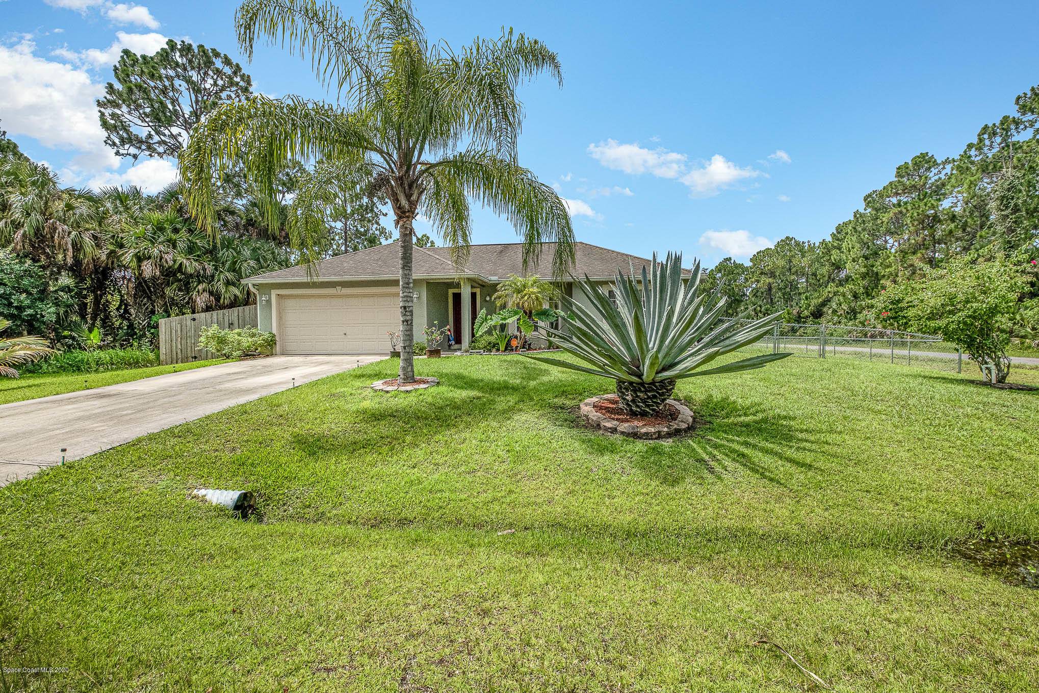 498 Scarlet Road Southwest Palm Bay, FL 32908 - Photo 2 of 24 a view of a house with a yard
