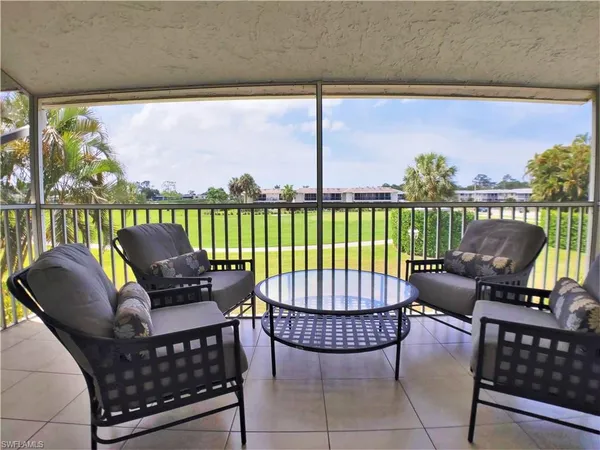 a balcony with furniture and a potted plant