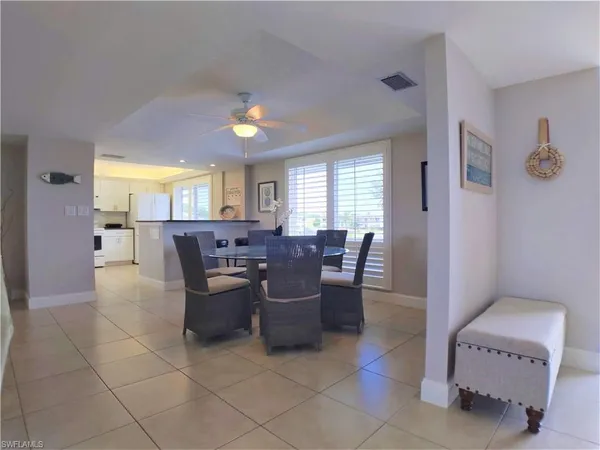 a view of a livingroom and a dining room with furniture