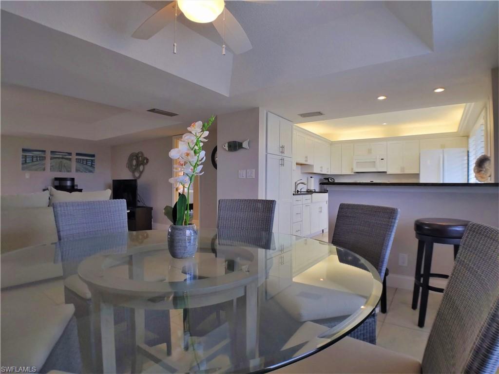108 Penny Lane, Unit 4 Naples, FL 34112 - Photo 15 of 33 a view of a dining room with furniture and wooden floor