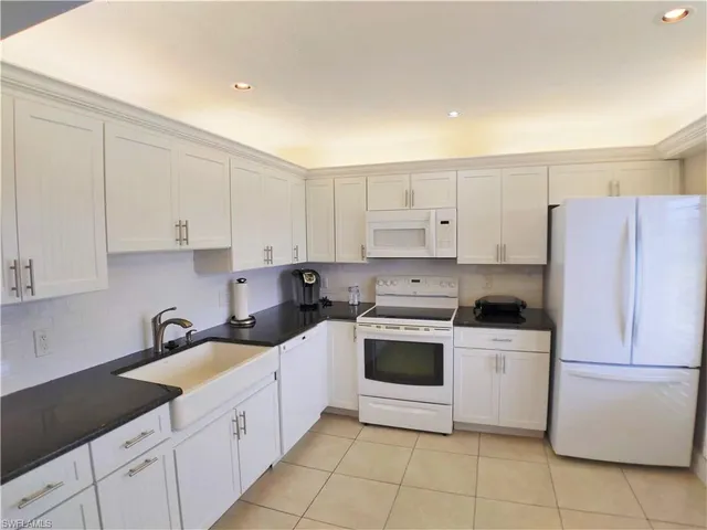 a kitchen with cabinets appliances and a sink