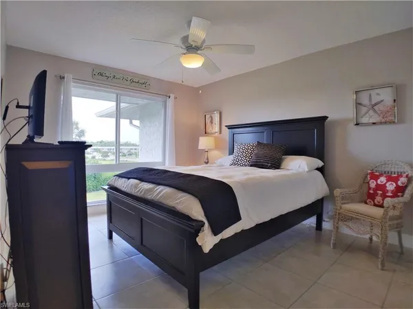 a bedroom with a bed and a television