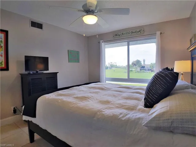 a bedroom with a bed and a tv